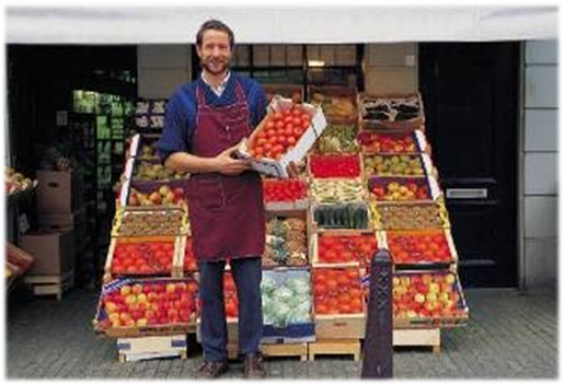 image of Farmer in front of produce stand